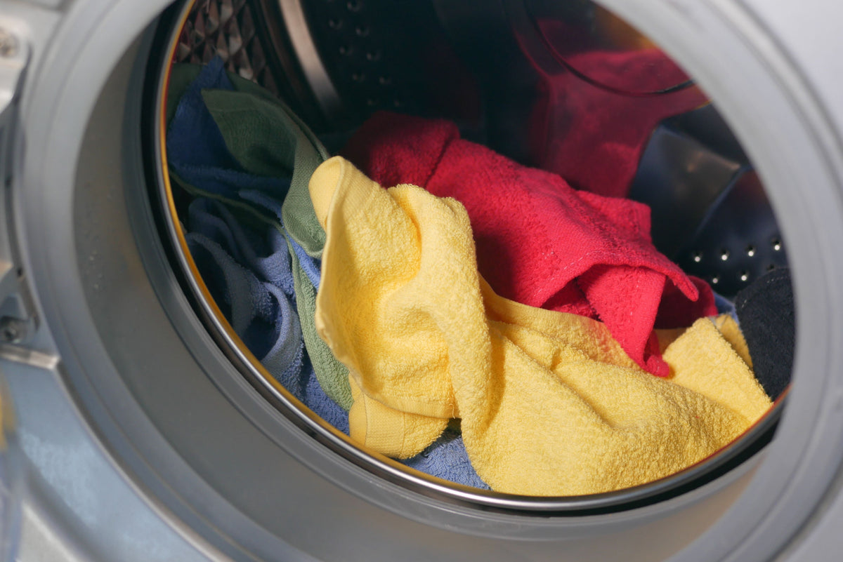 Bunte Wäsche in geöffneter Waschmaschine